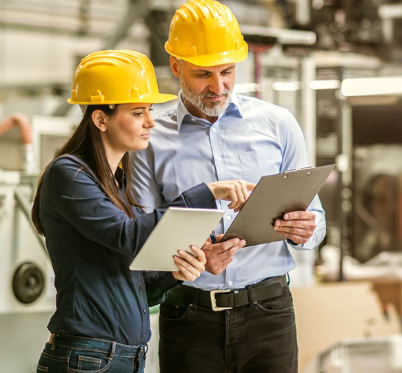 Two people using tablets in a safety inspection